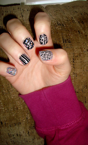 dark grey nails with sparkle,cheetah print,stripes and spots! I love my work (: