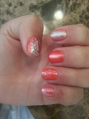 I applied two coats of neon orange polish, then I started playing with glitterish top coats.