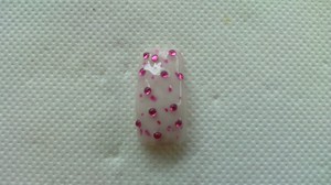 "Sweet as sugar, Sharp as a knife"
White acrylic with pink acrylic branded dots. Diamantés and gel overlay.