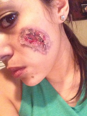 Special effect makeup, bloody wound on face.