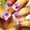 Acrylic nails with purple glitter.