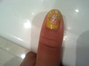 pretty yellow polish, pretty pink butterfly and glitter nail polish on top 
