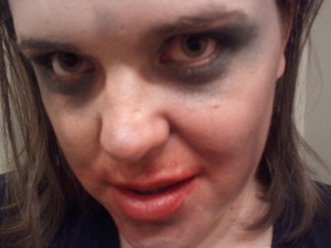 A cornicopia of eyeshadow=cheap zombie makeup
Smeared red lipstick=dried blood