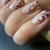 Nude nails with purple-gold polka dots