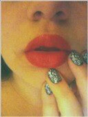 Matte red lips and leopard print nails.