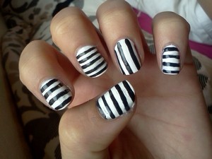 one hand is horizontal stripes with one vertically stripped nail, the other is vice versa.