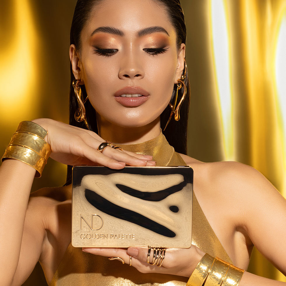 Model holding Natasha Denona Golden Palette