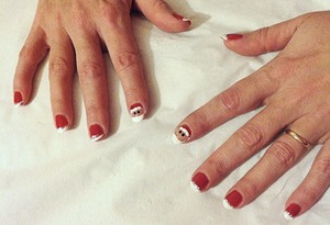 Red with white tips and Santa on index fingers 