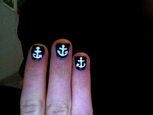 White anchors over black nail polish