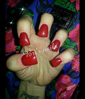 red acrylic on short flare tip nails