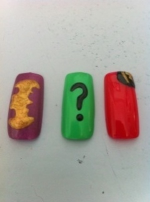 I was messing around and practicing some nail art, which is always fun and I decided to do a few Batman inspired nails. The purple nail is obviously representing Batman, the green one is The Riddler, and the red one is Robin. Enjoy!