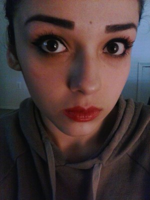 Red lipstick. Winged eyeliner. Cake face.