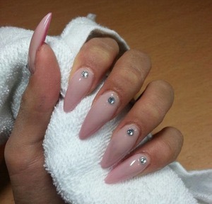 my homemade nude/pink stiletto acrylic nails with a white strass stone