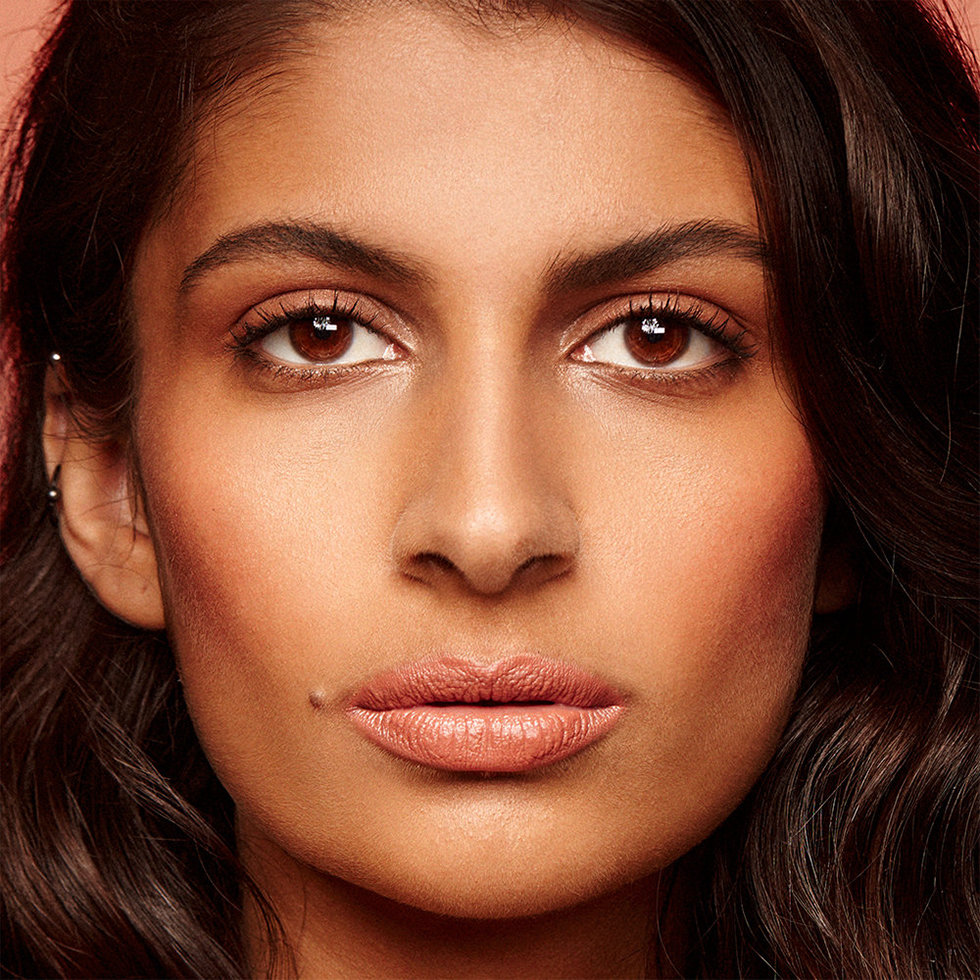 Nudestix model wearing the Nudies Blush Stick in Nude Peach