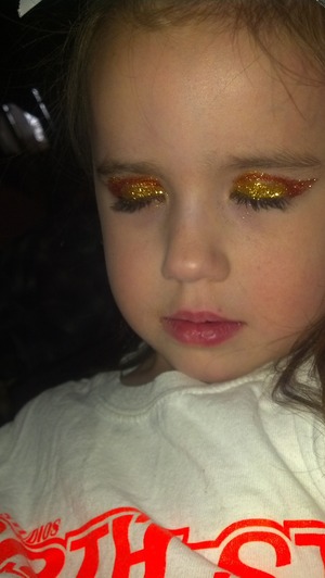 orange and yellow glitter and black liner