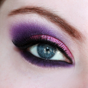 A pink glittery eye, with purple smoked out in the crease and lower lashline.