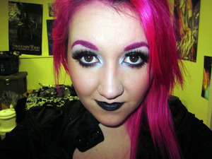 Pink brows, black lips, false lashes. 
