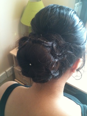 Elegant bun I did on my sister for a wedding. Back combed, small bouffant with a low sockbun and curls wrapped round the side with a pretty diamanté pin! 