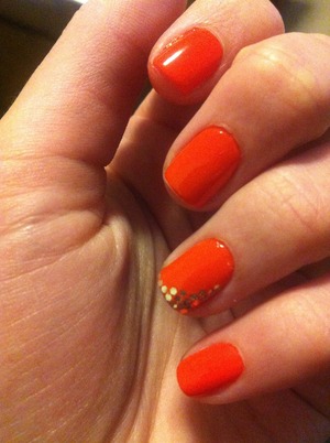 Orange nails with glitter detail