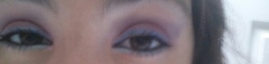 pink eye shadow on the lid, purple in the crease, champagne  color as the highlight, blue liquid liner on top eyelash line, and baby blue eye shadow underneath the eye.