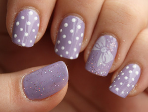 Base: Avon Loving Lavender
Holo glitter: Miss Selene 165
Polka dots made with acrylic paints. Bow tie stamped using fauxnad plate.

http://iloveprettycolours.blogspot.com/2012/03/avon-loving-lavender-cute-stamping.html