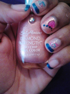 pink and blue Polish with a love tattoo and a pink gem