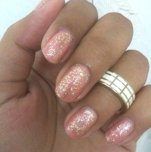 A coat of gold glitter on simple light pink painted nails