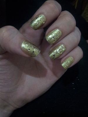 Golden nail polish with gold glitter