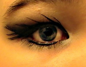 I put some black eye shadow as a base using it starting at the inner corner of my eye and pulling straight out at an angle and at the top/bellow my brow put white eye shadow and blended it with the black, then used my liquid eyeliner to make effects.