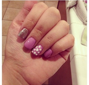 So cute purple nails while polka dots with silver glitter accent