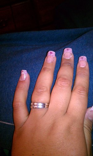 Acrylic nails with a pink french tip design. 