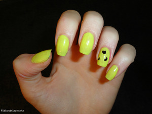 Yellow nails with small black hearts