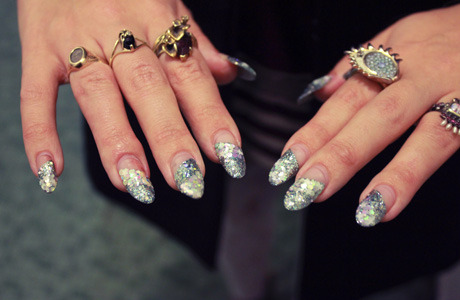 Elena’s nails look winter-wonderful with stripes of real glitter in shades of opal, silver, and ice blue.