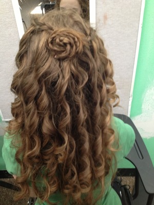 This is the result of two meeting waterfall braids twisted into flower formation in the back with curls.  :)