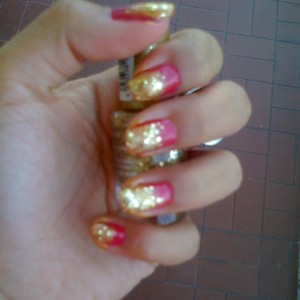 Pink nail polish and gradient glittery gold