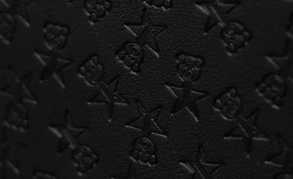 Shane Dawson Travel Bag embossed with little pig heads on spikes.