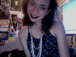 Dark lipstick, winged eyeliner, and pearls look fierce!- So great for going out