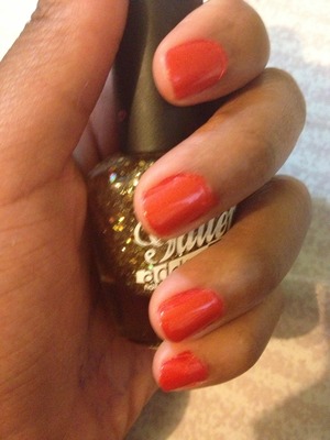 Red nye nails with gold glitter accent on thumb