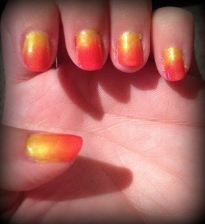 Gradient manicure using pink and yellow. 