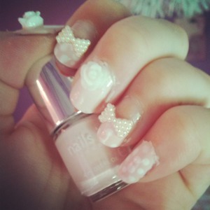 Pink nails with pearl bows and roses.